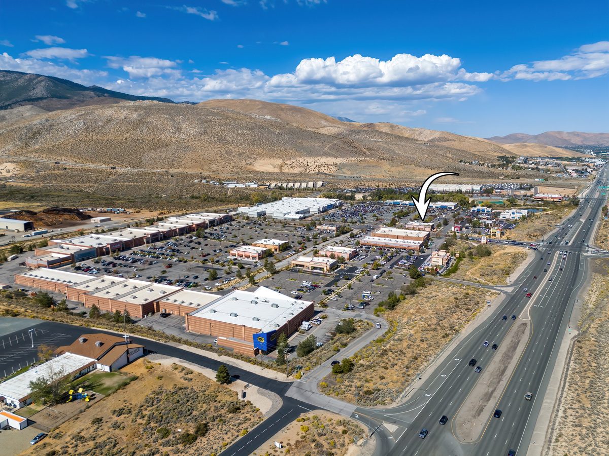 Aerial of a multi-tenant retail center along a highway
