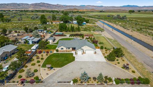 Aerial of a home on acreage with mountains behind