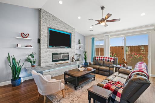 Living room with a stone fireplace wall
